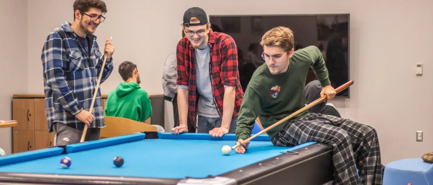 Three students playing pool